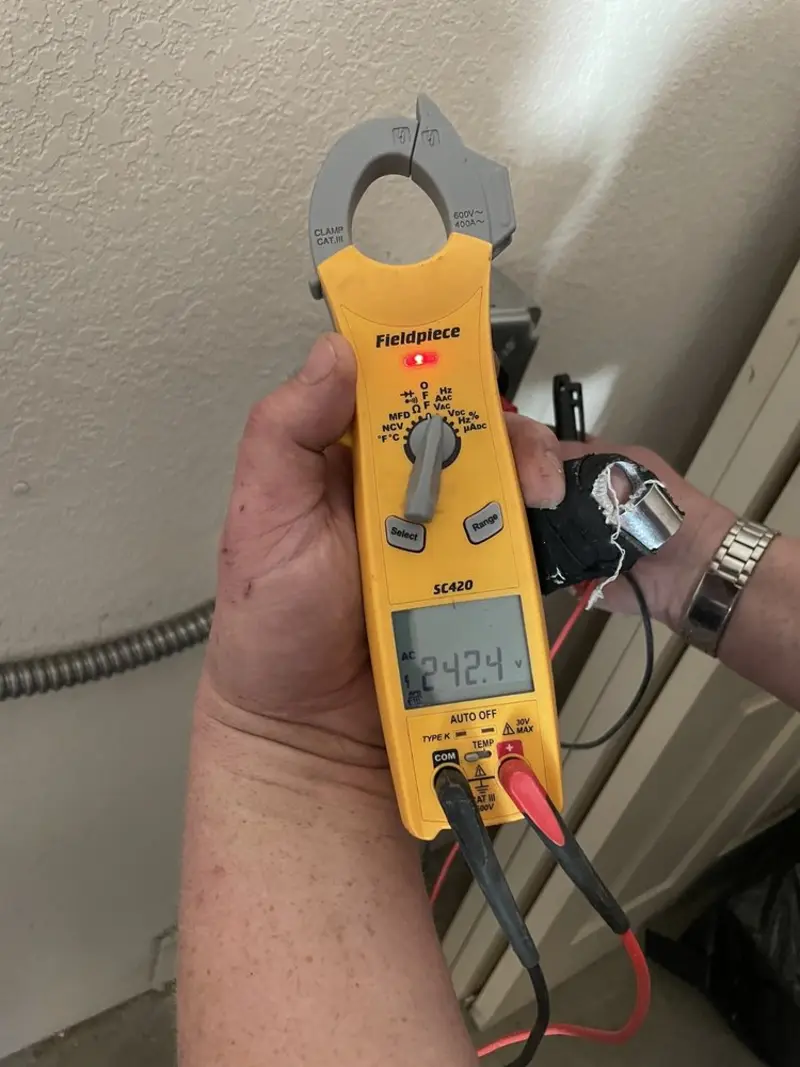 Voltage testing with clamp meter during Electrical Installation Services in Scott AFB
